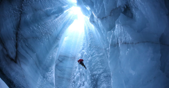 researchers climbing out of moulin